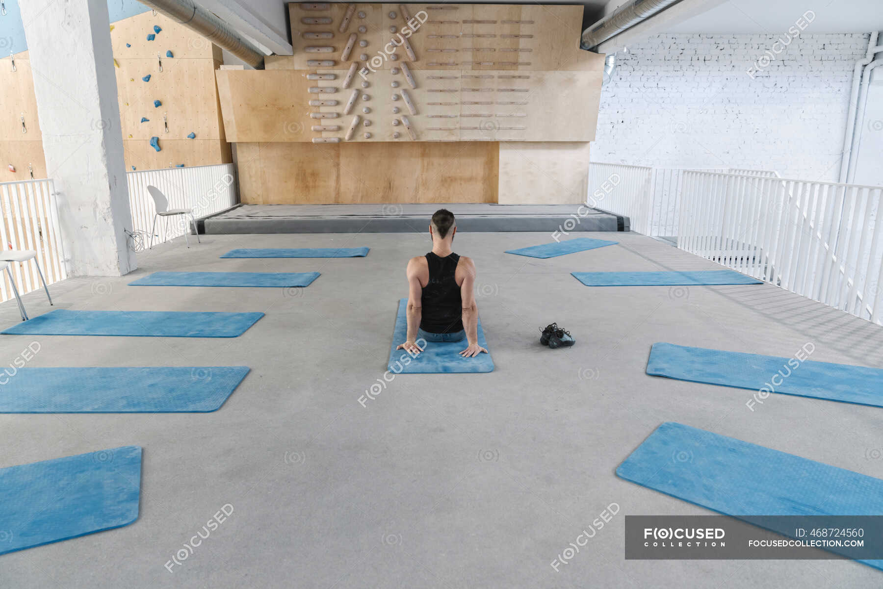 Man doing stretching exercises before climbing — practicing, one person Stock Photo 468724560