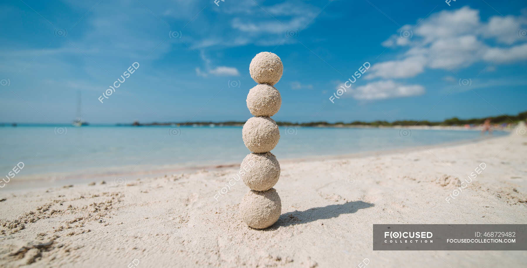 Sand balls stacked on a column on the beach, Menorca, Spain — island