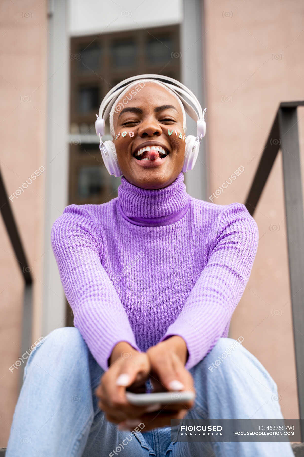 portrait-of-white-haired-woman-with-white-headphones-and-stickers-in