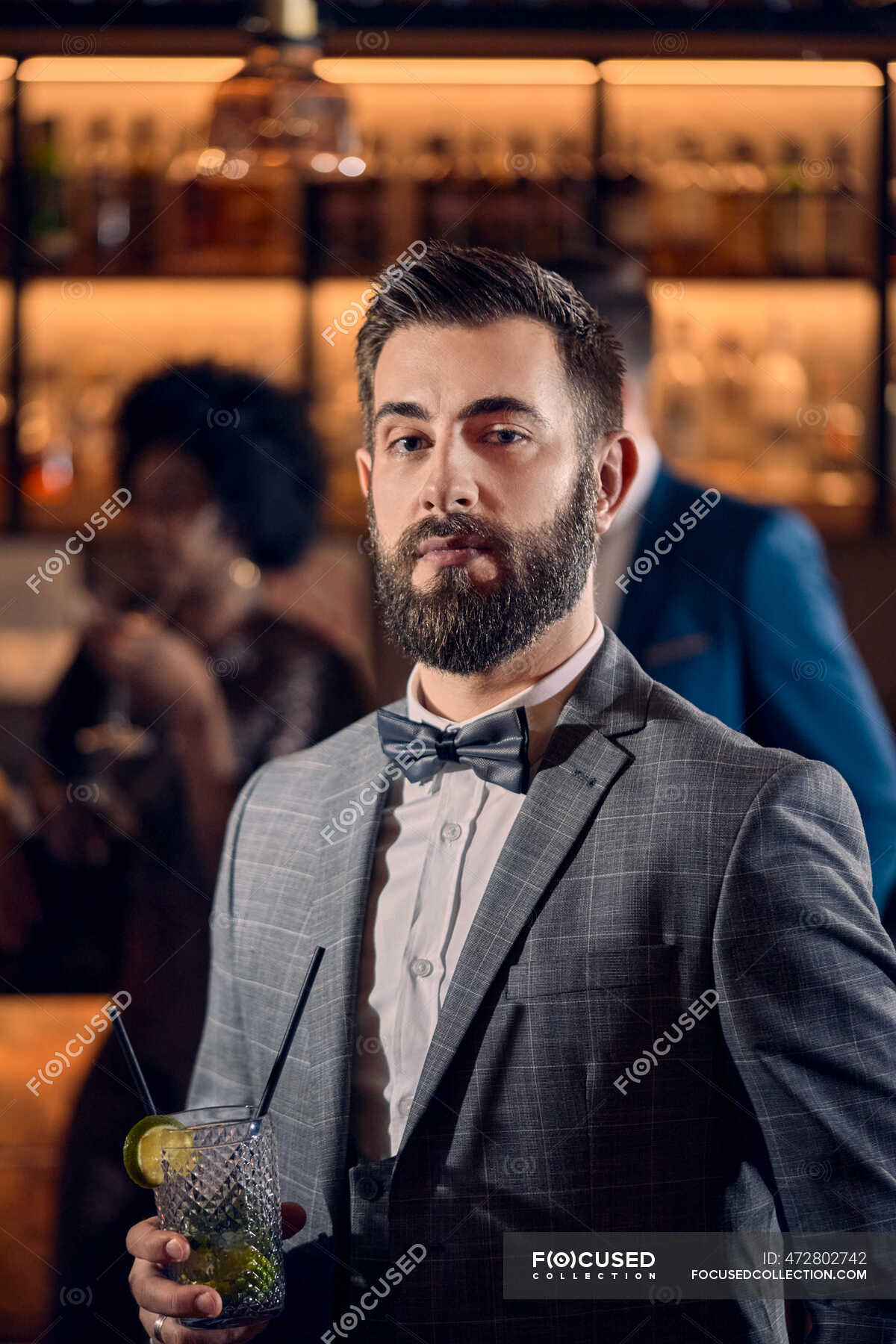 portrait-of-a-young-man-having-a-cocktail-in-a-bar-holding-mid-adult