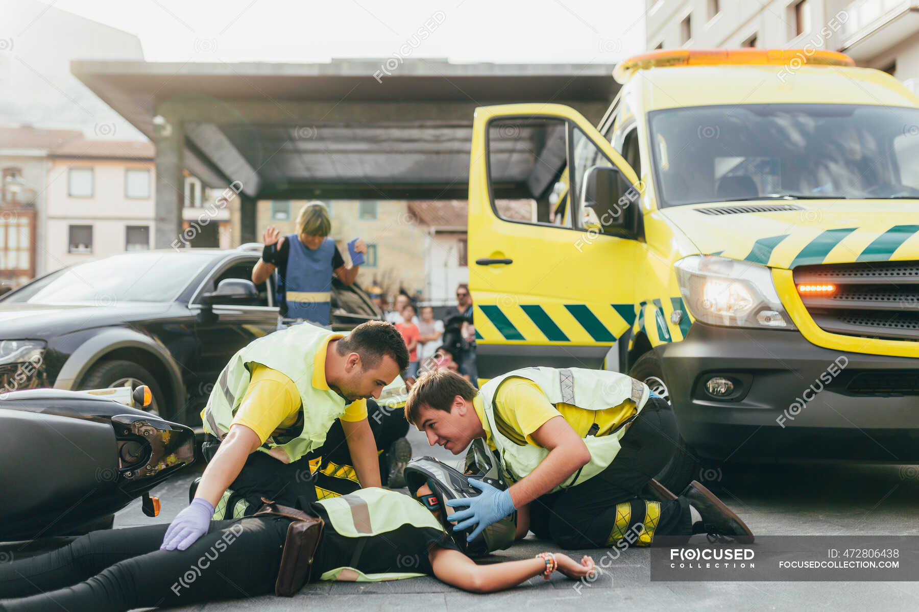 Paramedics helping crash victim after scooter accident — emergency ...