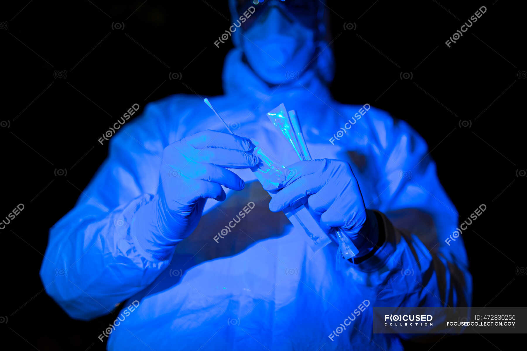 Doctor Wearing Protective Clothing Holding Viral Swab Test