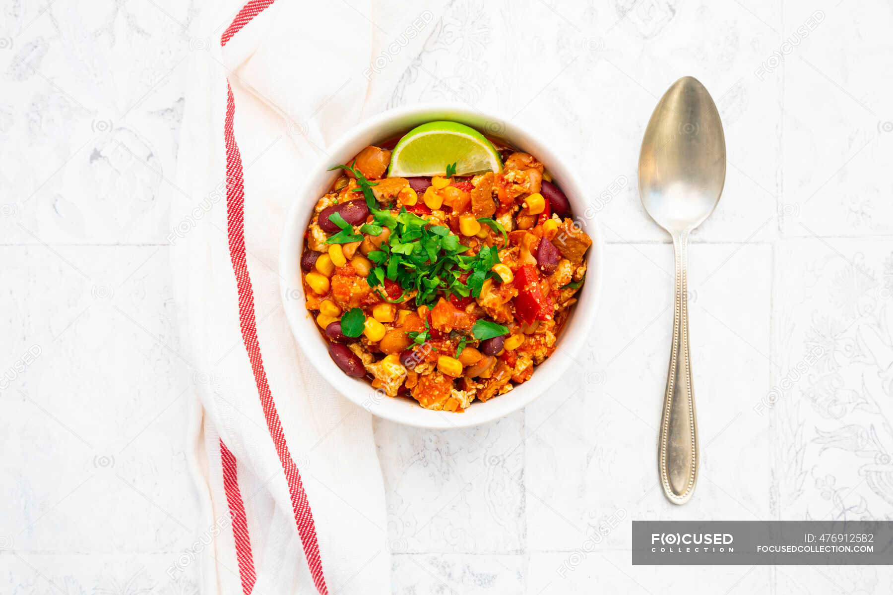 Bowl of vegetarian chili with tofu, corn, kidney and pinto beans