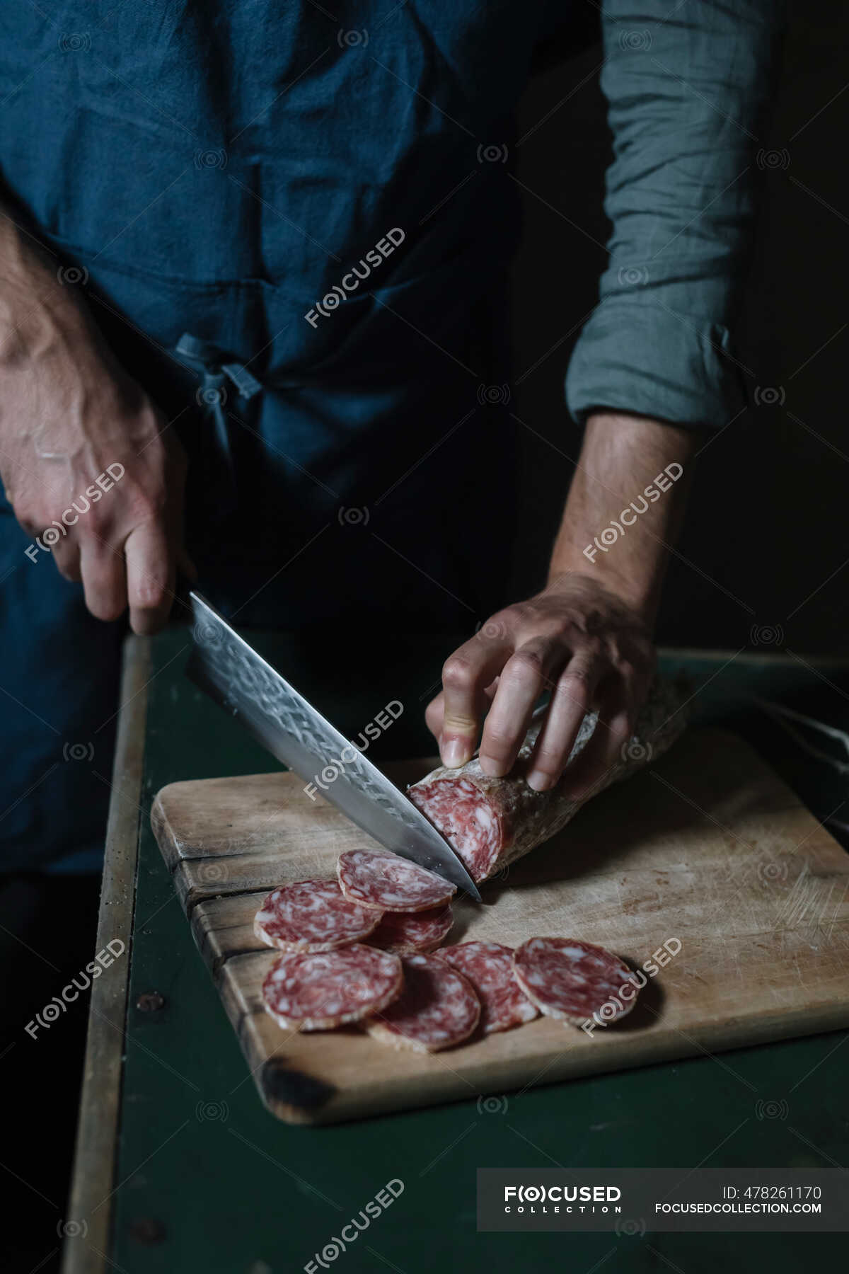 Man cutting meat on chopping board stock photo