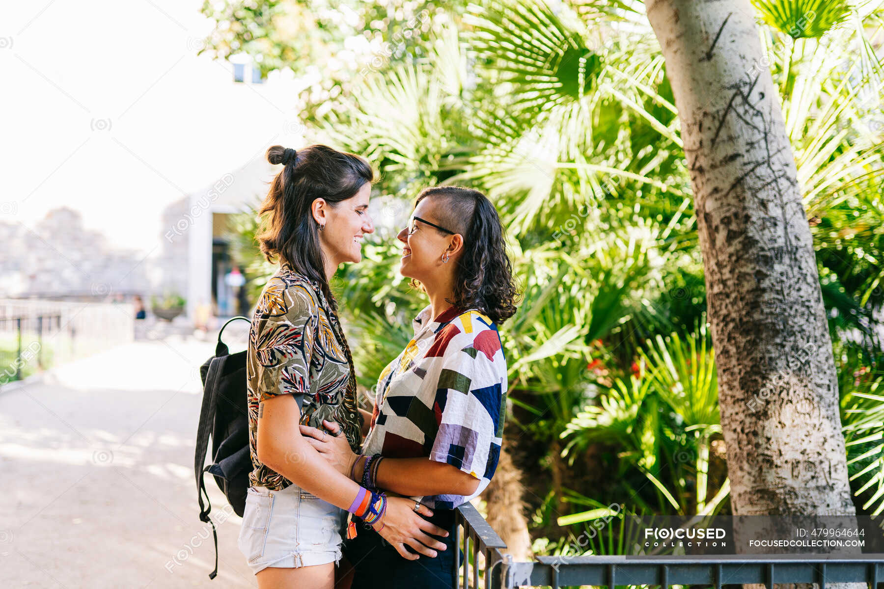 Affectionate Lesbian Couple Looking At Each Other Standing Outdoors