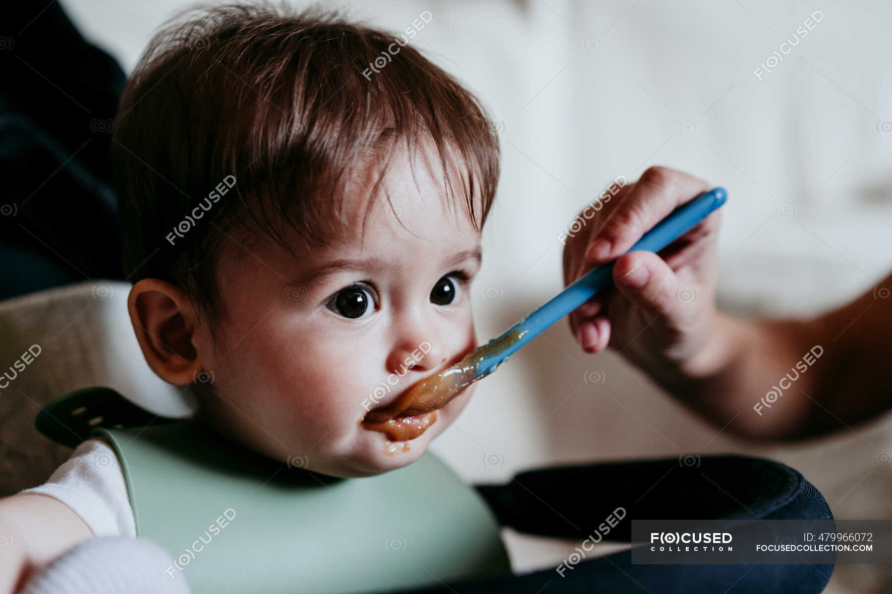 mother-s-hand-feeding-food-to-baby-boy-at-home-30-40-years-cute