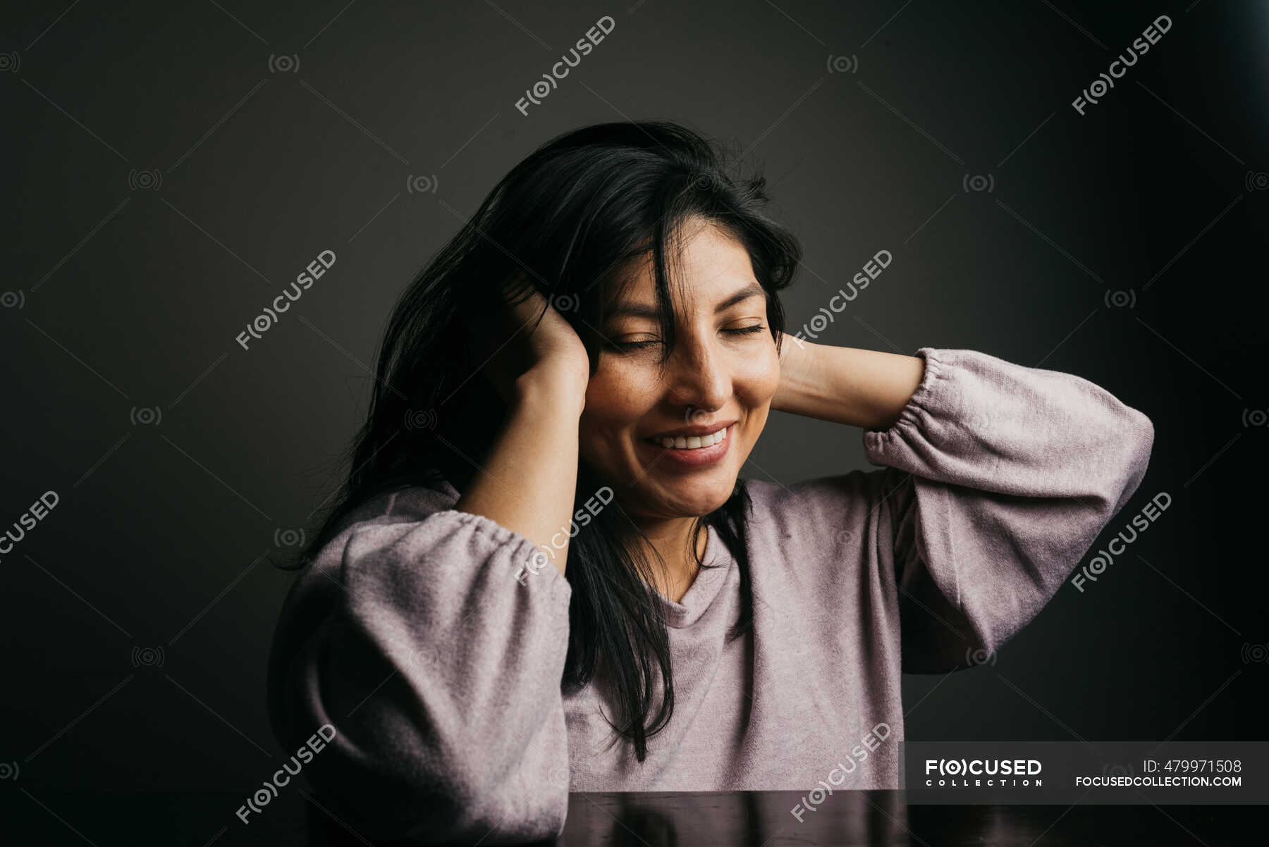 sad girl sitting against wall