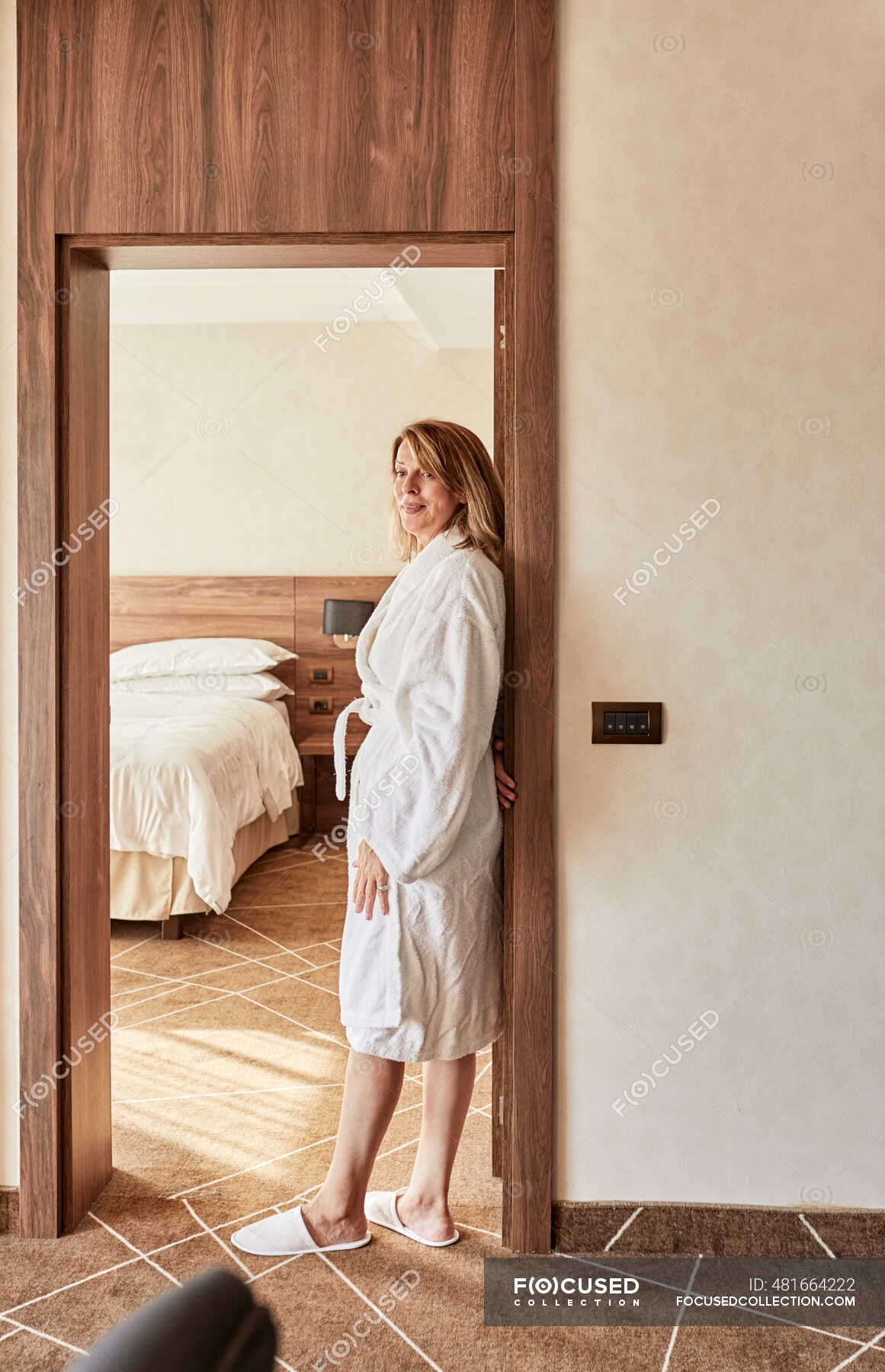 Beautiful Girl In Hotel - Beautiful retired senior woman standing at doorway in hotel room â€” Adults,  Luxury Hotel - Stock Photo | #481664222