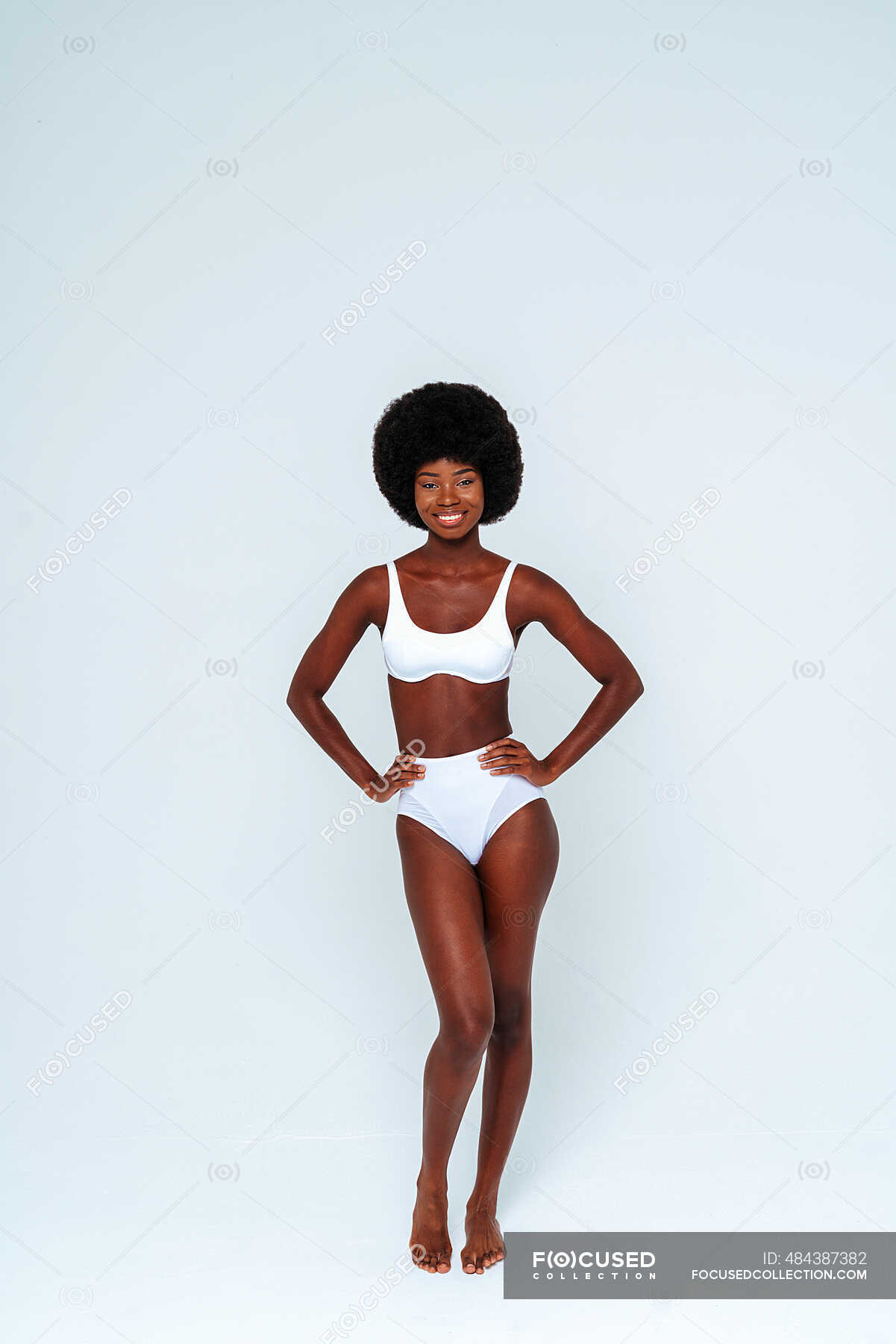 Skinny female model wearing bikini standing against white background —  individuality, hair - Stock Photo | #484387382