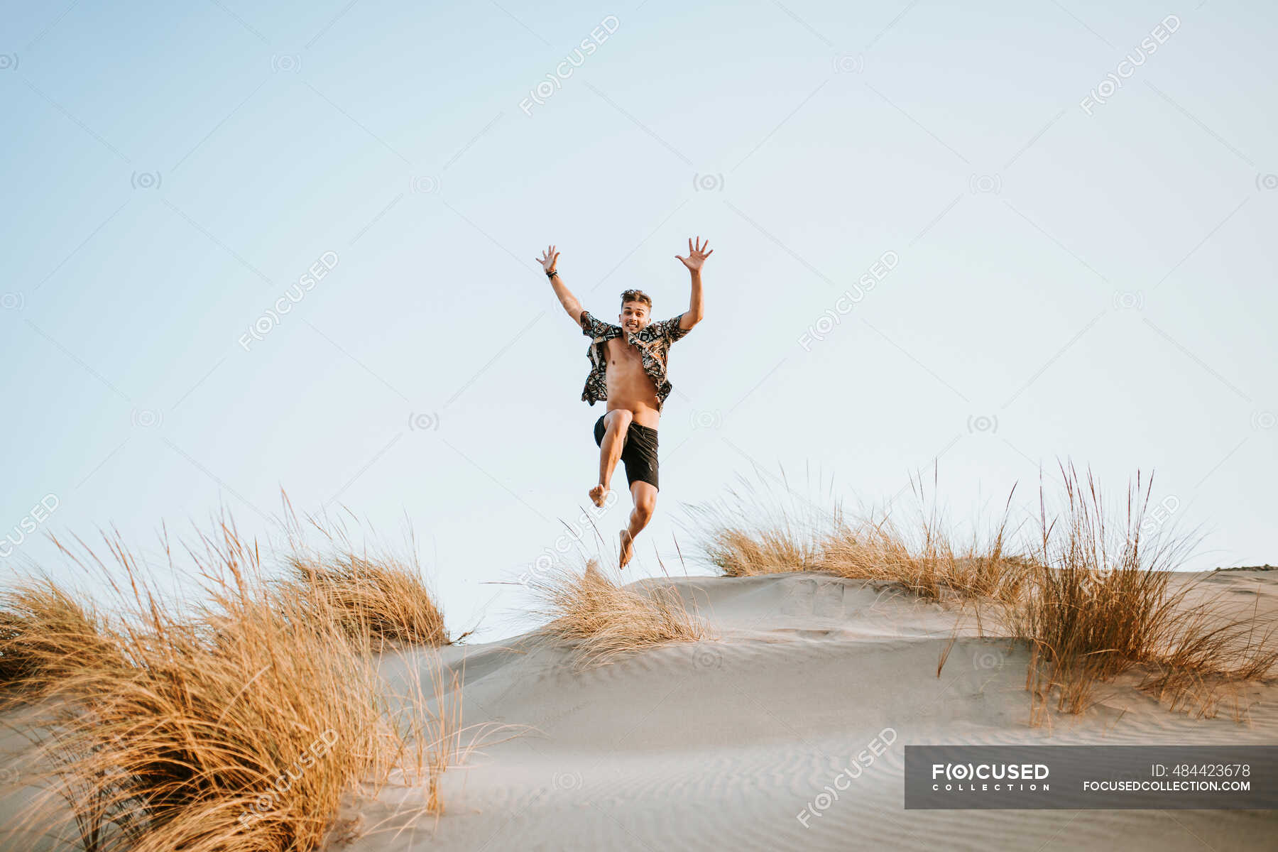 Cheerful young man jumping over sand at Almeria, Tabernas desert, Spain