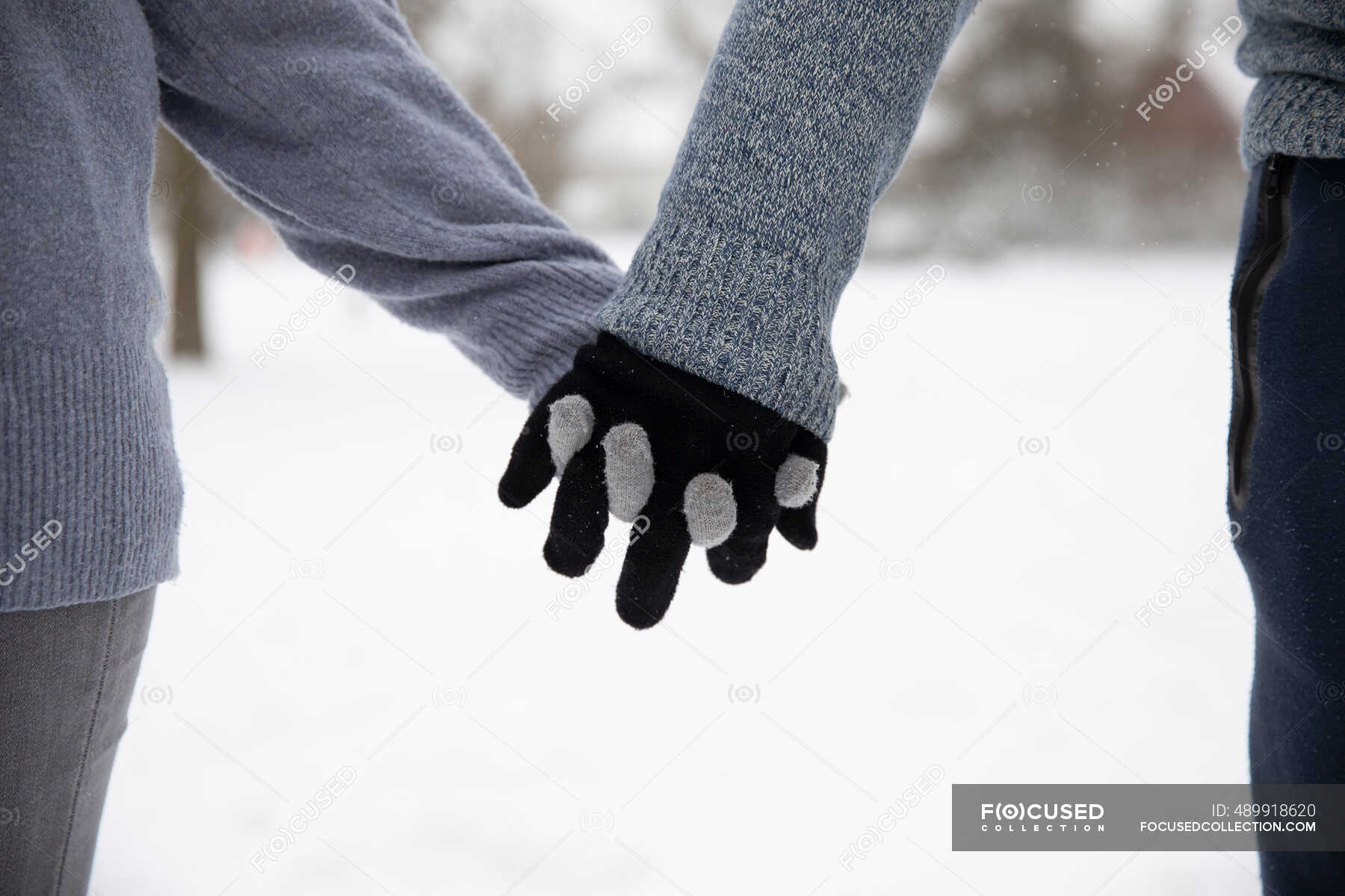 Couple with gloves holding hands during winter — hand in hand, Active Seniors - Stock | #489918620