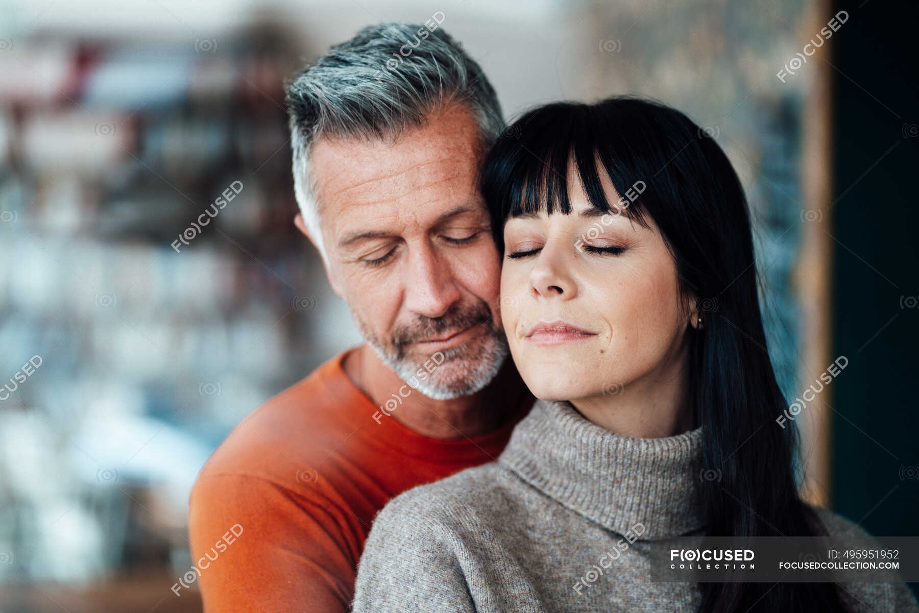 Mature woman leaning with eyes closed on man at cafe — closed eyes, Differential Focus