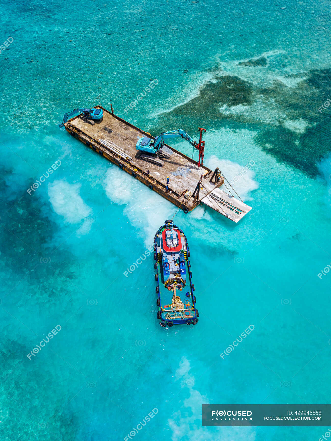 aerial-view-of-earth-movers-handling-poles-on-floating-platform-in-male