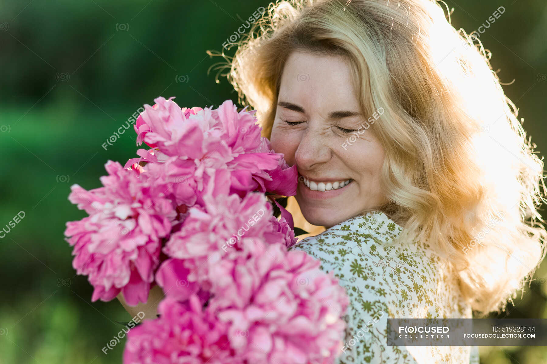 Cheerful woman embracing pink flowers — blond, headshot - Stock Photo ...