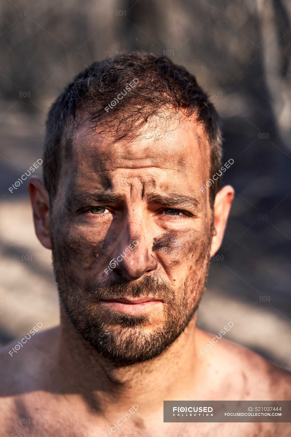 man-with-ash-and-dirt-on-face-burnt-fire-stock-photo-521037444