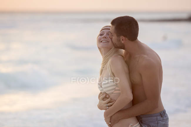 Pareja besándose en la playa — Longitud de tres cuartos, joven - Stock  Photo | #164836038