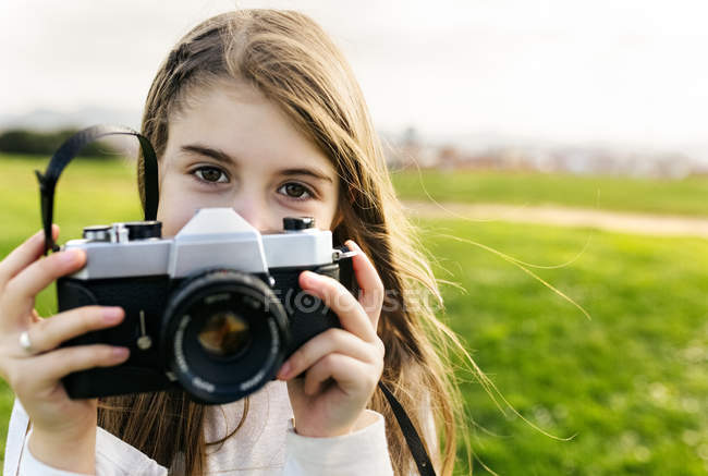 Chica sosteniendo una cámara retro - foto de stock