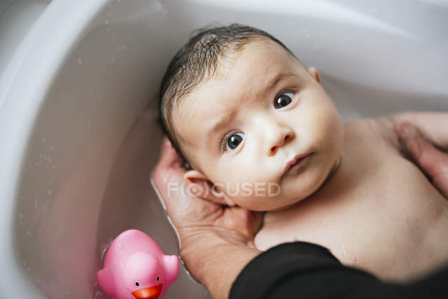 Woman bathing baby girl — Stock Photo