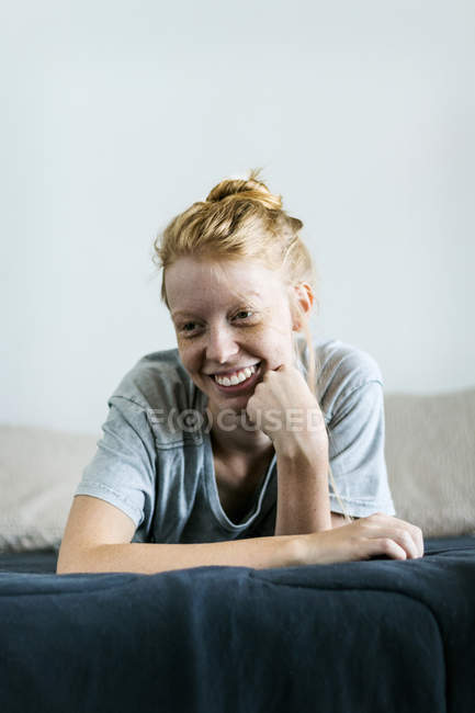 Ginger woman lying on couch — Stock Photo