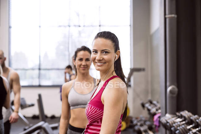 Young smiling women in gym — Stock Photo