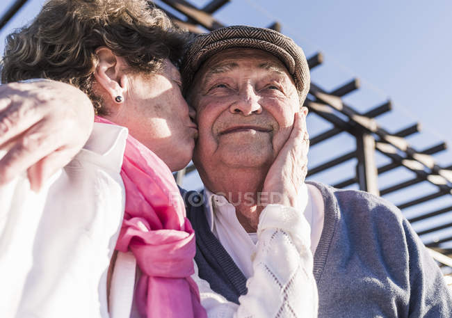 Senior man kissed by wife — Stock Photo