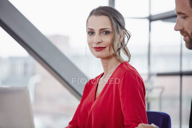 Smiling woman standing in office — Stock Photo