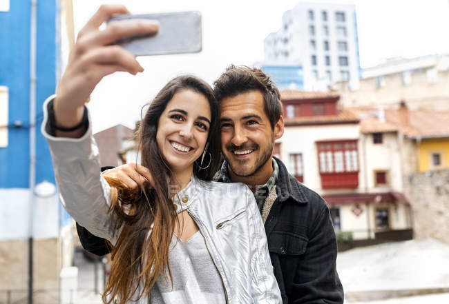 Smiling couple taking selfie — Stock Photo