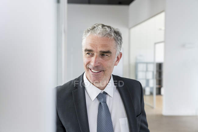 Businessman standing in office — Stock Photo