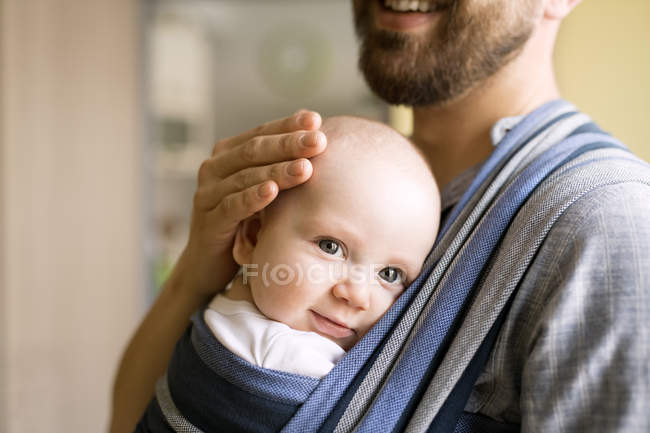 Father with baby son in sling — Stock Photo