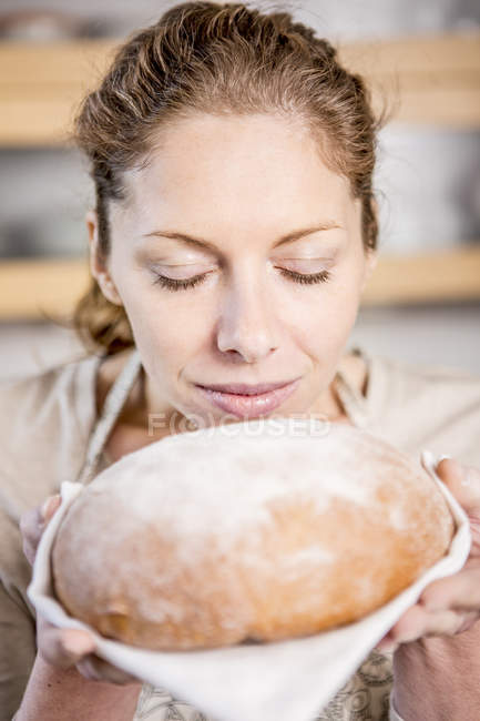 Woman holding loaf of bread — Stock Photo