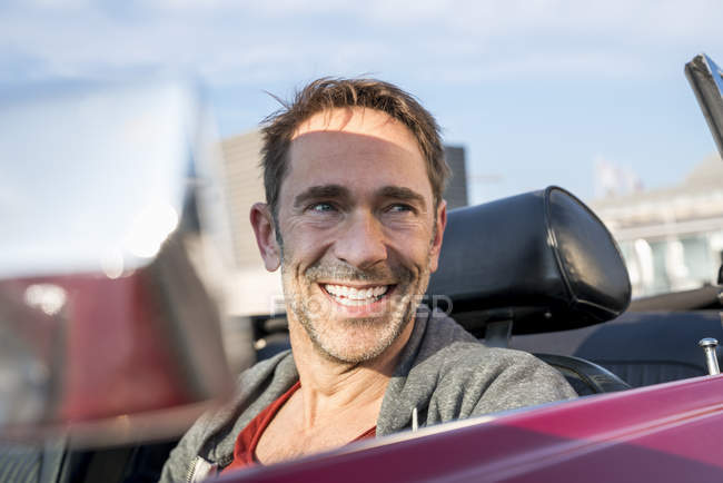 Man sitting in sports car — Stock Photo