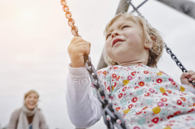 Mother with daughter on swing — Stock Photo