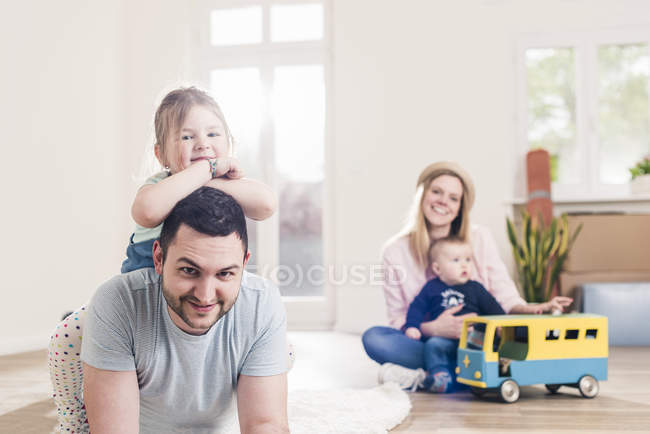Portrait of happy young family at home — Stock Photo