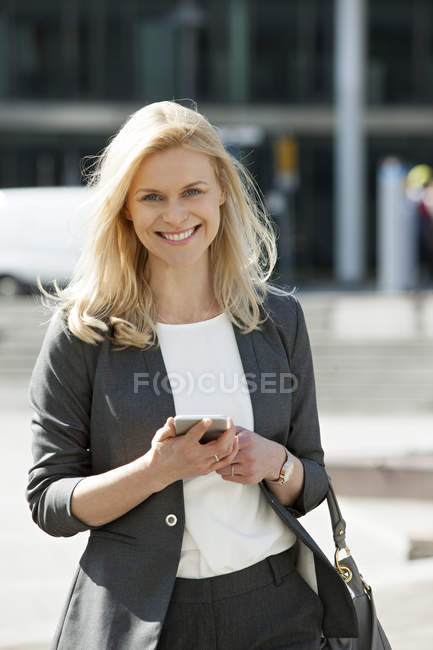 Femme d'affaires utilisant un téléphone portable — Photo de stock