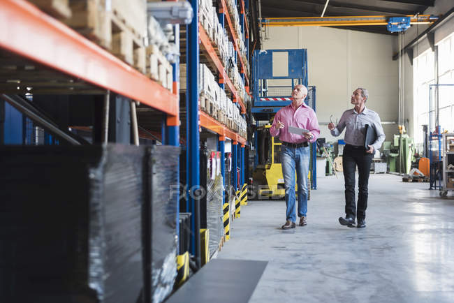 Homens andando no salão industrial — Fotografia de Stock