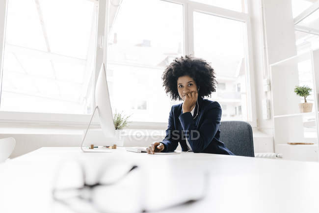 Businesswoman sitting in office — Stock Photo