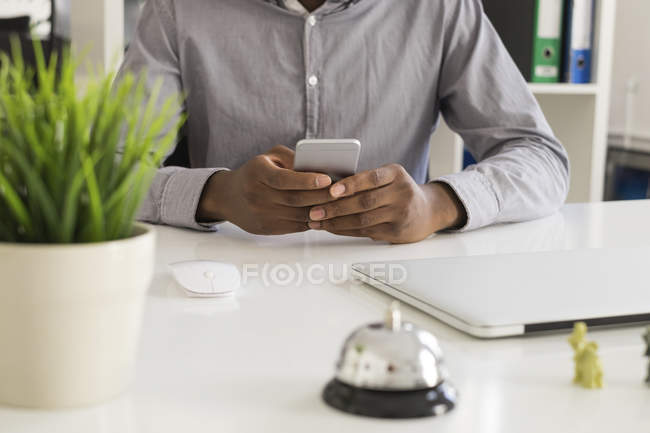 Mann am Schreibtisch mit Smartphone — Stockfoto