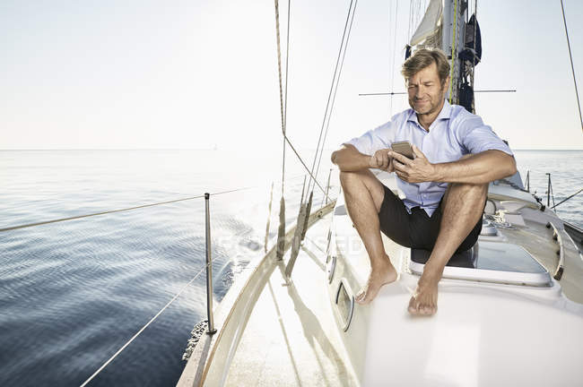 Man sitting on sailing boat — Stock Photo
