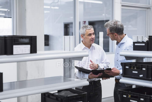 Managers with folder standing in company — Stock Photo