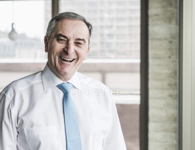 Senior manager standing in office — Stock Photo