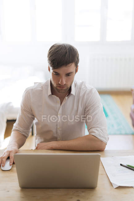 Man working from home with laptop — Stock Photo