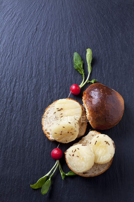Вид сверху на ломтики хлеба с сыром и красной редиской — стоковое фото