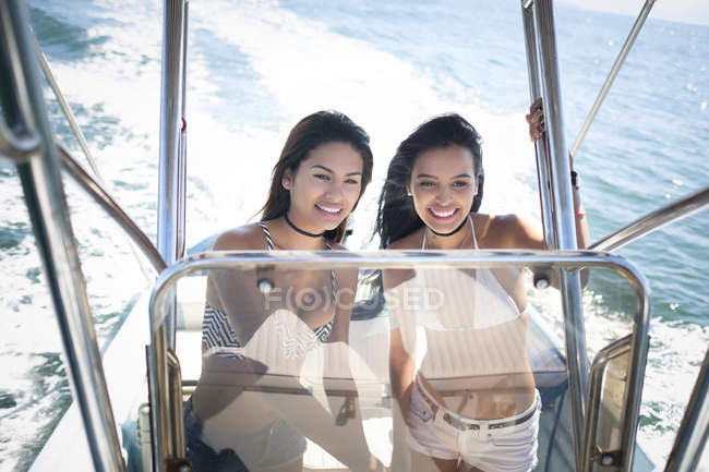 Two young women navigating a boat — Stock Photo