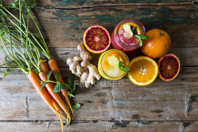 Vista dall'alto di agrumi a fette con succo e carote — Foto stock