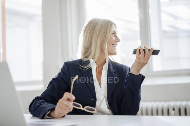 Businesswoman using cell phone — Stock Photo