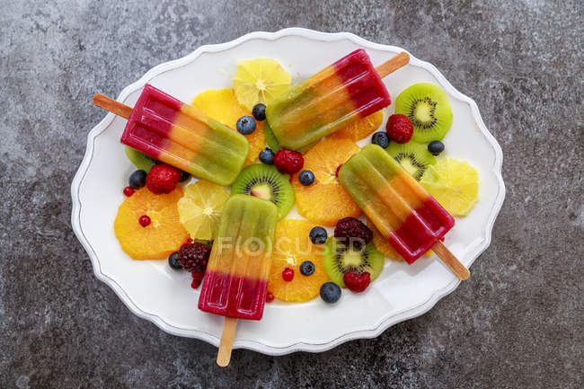 Homemade fruit smoothie ice lollies — multicolored, top view - Stock Photo  | #172097014