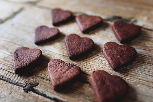 Homemade heart-shaped chocolate cookies on wood — Stock Photo