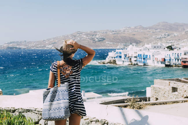 Mykonos City, Greece, Woman looking to Little Venice from the popular Windmills — Stock Photo