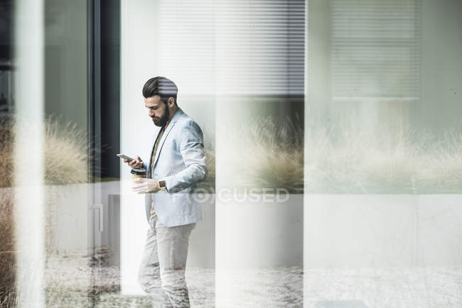 Porträt eines jungen Geschäftsmannes mit Smartphone — Stockfoto