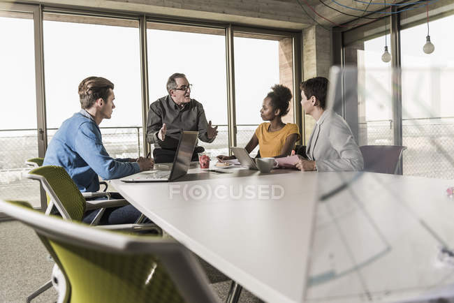 Réunion d'affaires dans un bureau moderne avec des collègues multiraciaux — Photo de stock